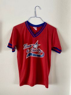 "Vintage 90's T&C Jersey, #4 BARRON Good condition, normal wear to be expected for the age of the item. Thick sweatbands on V-neck collar and short sleeves, Reminiscent of the 70's. Super soft and well loved. A few tears on left shoulder, as shown in pics. Graphic is still vibrant, as well as the name and number across back. Fun vintage piece! Measurements lying flat: pit to pit: 18.5\" shoulders: approx 17\" top of shoulder to bottom hem (length): 27\" sleeve: 13\"" Affordable Vintage T-shirts For Sports Season, Cheap 90s Sports T-shirt, Throwback Short Sleeve Tops For Sports, Throwback Short Sleeve Tops For Sports Events, Retro Sports Fan Merchandise Tops, Retro Tops For Sports Events In Summer, Retro Tops For Summer Sports Events, Retro Summer Tops For Sports Events, Throwback Baseball Fan Tops