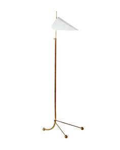 a floor lamp with a white shade on the top and a gold metal pole underneath it