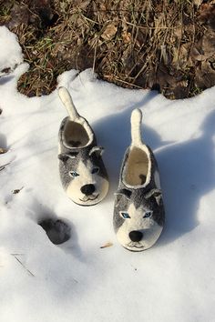 two slippers that have been made to look like dogs in the snow with their noses open