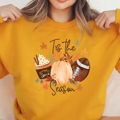 a woman wearing a yellow tis the season sweatshirt