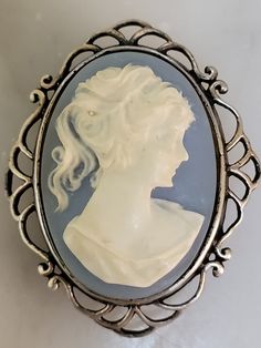 Very delicate blue and white cameo set in sterling silver. The material of the cameo is a type of resin. It is not cold to the touch. See photos for measurements.  Any questions or concerns please ask.  Check out my other shop Arlettemichelle just put my shop name in the etsy search bar all one word.  My son John's artwork Jmoriginalart or Jmoriginalart.com Victorian Blue Cameo Jewelry, Blue Cameo Jewelry For Formal Occasions, Formal Blue Cameo Jewelry, Wire Wall Basket, Silver Gift Wrap, Vintage Blue And White, Shop Name, African Queen, Cameo Necklace