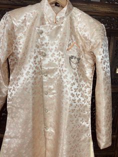 Gorgeous Peach Color Floral Indo- Western Outfit !! Size 38 - Chest Meaurement 40 inches Size 40 - Chest Meaurement 42 inches Item : Men Indo Western Ready to Wear : Yes Kurta Color : Peach Churidar Pajama Color : Light Gold Pocket : Yes Fabric : Silk Sleeves : Full Sleeves Work : Fancy buttons. Disclaimer -For sizing please refer to the Size Chart given in the listing with the pictures. - Please do NOT go by the size of the Kurta that you already have from another maker. All makers have differe Peach Kurta With Zari Work And Long Sleeves, Long Sleeve Peach Kurta With Zari Work, Peach Kurta With Zari Work, Peach Long Sleeve Kurta With Zari Work, Peach Long Sleeve Kurta For Wedding, Long Sleeve Peach Kurta For Festive Occasions, Peach Long Sleeve Kurta For Festive Occasion, Peach Long Sleeve Kurta For Eid, Peach Kurta For Wedding And Festivals