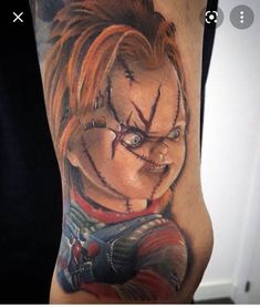 a close up of a person's arm with a tattoo on it, and an evil clown