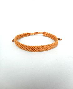 "Ochre yellow macrame bracelet Mens surf bracelet Copper beads Friendship bracelet Handwoven wristband Unisex gift Adjustable Knotted jewelry This handknotted bracelet is made with ochre yellow waxed string. It is adjustable and has a sliding knot closure in order to fit a lot of sizes. Due to its waxed threads,the bracelet is very durable and water resistant. Width: 0.9cm\" Other bracelets in my shop: https://www.etsy.com/shop/LuckyRatJewellery?section_id=14498120&ref=shopsection_leftnav_2s Rat Jewellery, Yellow Macrame, Knotted Jewelry, Surf Bracelet, Surf Jewelry, Ochre Yellow, Friendship Bracelets With Beads, Bracelet Mens, Unisex Gift