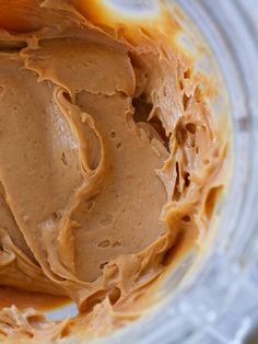 a bowl filled with peanut butter on top of a table