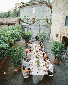 a group of people sitting around a long table