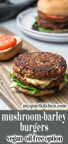 a burger with lettuce and tomato on it sitting on a wooden cutting board