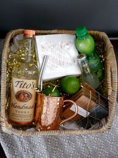 a wicker basket filled with alcohol and condiments for a party or brunch