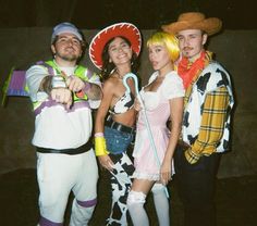 three people dressed in costumes posing for a photo