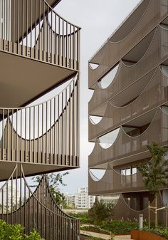 two tall buildings with balconies next to each other