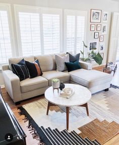 a living room filled with furniture and lots of windows