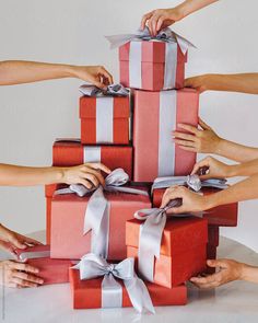 several hands holding wrapped presents with ribbons on them by jovo studio for stocks & bonds