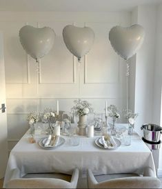 the table is set with heart shaped balloons