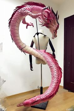 a mannequin is dressed up as a pink dragon