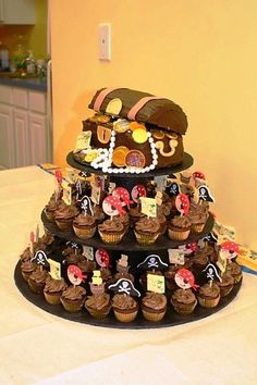 a pirate themed cake with cupcakes on it