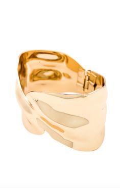 The Abstract Textured Cuff Bracelet in Gold is a must-have for the modern woman who exudes elegance and grace. Crafted with a touch of magic, these bracelets effortlessly elevate any outfit, adding a golden glow to your wrist. Embrace your inner goddess and shine with confidence. And layer it up. These bracelets were made for it. 18k gold-plated steel Hinge closure Textured effect Measures approx 2.4" in diameter Steel base: Provides durability and strength Chic Yellow Gold Cuff Jewelry, Gold Open Cuff Elegant Jewelry, Elegant Gold Cuff Bracelet With Jubilee Detail, Elegant Gold Cuff Bangle, Chic Polished Finish Bangle, Elegant Gold Open Cuff Jewelry, Gold-plated Polished Cuff Bracelet For Formal Occasions, Elegant Metal Open Cuff Bracelets, Elegant Metal Bangle Cuff Bracelet