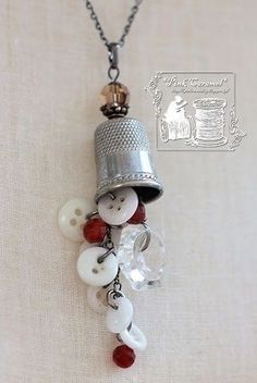 a necklace with buttons and a bell on it