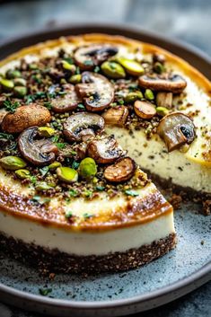 a cheesecake with mushrooms and pistachios on top sits on a plate