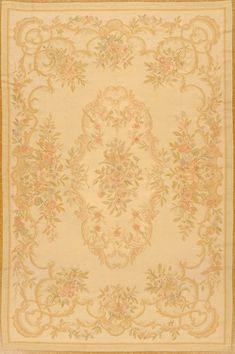 an antique rug with flowers and leaves on the bottom, in cream colors is shown