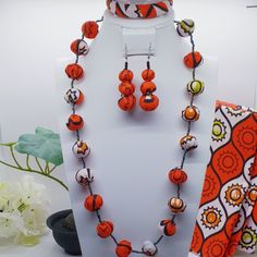 "This vibrant authentic African hand-crafted beaded necklace ,earrings and bangle set is the perfect addition to your wardrobe and perfect unique gift for her! Size: Necklace: 11\" Length & 8\" Width Earrings: 2.2\" Bangle: 2.6\" Diameter Color: Red & White Shape: Round beads Material: African Ankara fabric beads & glass seed beads with barrel screw twist clasps. Due to screen resolution, color may appear different than the actual product. Fabric patterns may not look identical due to variances Adjustable Round Multicolor Jewelry Sets, Adjustable Multicolor Jewelry Sets For Festivals, Adjustable Orange Jewelry For Festivals, Orange Wooden Beads Jewelry For Festival, Large Beads Jewelry For Festivals And Gifts, Handmade Adjustable Jewelry Sets For Festivals, Unique Orange Jewelry With Wooden Beads, Festival Jewelry With Large Beads As Gift, Festive Large Beads Jewelry As Gift