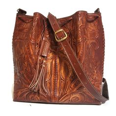 Leather Bag For Women. Featuring a gorgeous chiseled design, this rustic Tooled Leather Purse will help you bring a little vintage flair to your everyday outfit. The perfect size for fitting all of your everyday essentials, this purse was actually handmade with love and care by talented Mexican artisans , giving it a rustic touch that's hard to find in stores.  💮 Measures : height:29 cm.  11.2 inches width : 28cm.  11 inches base:13 cm. 5 inches detachable adjustable large strap: 43inches  110 Vintage Leather Shoulder Bag With Engraved Details, Vintage Engraved Leather Shoulder Bag, Vintage Leather Shoulder Bag With Engraving, Leather Shoulder Bag Engraved For Everyday Use, Engraved Leather Shoulder Bag For Everyday, Everyday Leather Shoulder Bag Engraved, Brown Engraved Bags For Everyday Use, Brown Engraved Leather Shoulder Bag, Engraved Leather Shoulder Bag For Daily Use