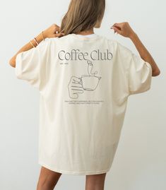 Our T-shirt is a must-have for every member of the Coffee Club team. ♡ Embrace the perfect blend of style and comfort while showcasing your passion for the brew that fuels your day. Ideal for coffee lovers who want to wear their enthusiasm with pride! If you have any special requests or unique ideas, please don't hesitate to contact us. ADDITIONAL DETAILS: ♡ Made from 100% cotton. Perfect for casual wear and everyday wear. ♡ Fabric weight: 170 - 180 g/m² ♡ Neck and shoulder tape ♡ Double seam on Coffee Merchandise Ideas, Coffee Shirt Ideas, Coffee Shop Merch, Coffee Shop Shirt, Coffee Merch, Handpainted Tote Bags, Coffee Shop Branding, Coffee Tees, Coffee Club