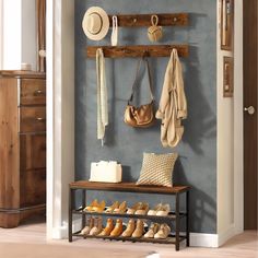 a coat rack with shoes and hats on it next to a wall mounted shoe rack