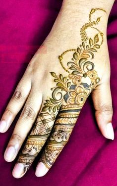 a woman's hand is decorated with hennap and intricate designs on it