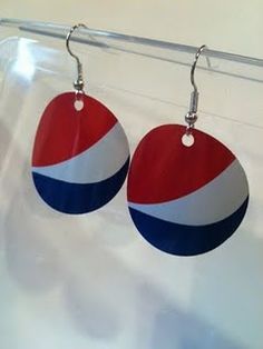 two red, white and blue earrings hanging from a hook