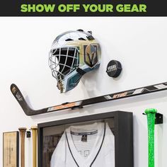 an ice hockey goalie's helmet is mounted on the wall next to his gear