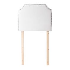 a white headboard with studding on it and wooden sticks sticking out from the side