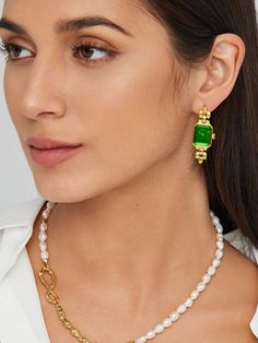 Embrace the allure of our Drop Emerald Green Earrings, meticulously crafted from eco-conscious gold vermeil. Featuring a rectangular face reminiscent of a vintage watch, these earrings showcase an emerald green hue exuding elegance and class. The unique design and rich color make them an undeniable standout, perfect for infusing any outfit with a touch of luxury. Pair them with a minimalist outfit for maximum impact.r maximum impact.r maximum impact. Details Recycled Silver: 18ct gold vermeil Ge Formal Rectangular Earrings With May Birthstone, Timeless Rectangular Pendant Jewelry, Classic Green Drop Earrings, Timeless Green Earrings For Formal Occasions, Timeless Green Earrings For Formal Events, Timeless Green Jewelry For Evening, Timeless Green Evening Jewelry, Classic Gold Plated Rectangular Earrings, Luxury Rectangular Gemstone Earrings