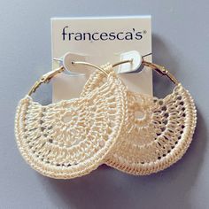 two pairs of crocheted hoop earrings are shown in front of a white card