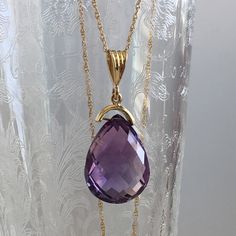 Details: Lovely vintage amethyst pendant and 14K gold necklace. The amethyst is faceted, and has an amazing sparkle glow. The amethyst measures 15.19 x 19.67 x 10.37mm, and is roughly 14.5 carats. This pendant is sold with a 14K gold chain, and the chain is modern. Please ask all necessary questions prior to placing an order! Size: The chain measures 16 inches, and the pendant is 1 1/4 inches. Condition: The overall all condition of this piece is very good. Purple Drop Necklace For Formal Occasions, Formal Purple 14k Gold Necklace, Formal Purple Drop Necklace, Formal Faceted Amethyst Necklace, Formal Drop Amethyst Necklaces, Formal Amethyst Drop Necklace, Formal Drop Amethyst Necklace, Teardrop Amethyst Necklace For Formal Occasions, Formal Teardrop Amethyst Necklace