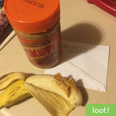 a banana peel sitting on top of a counter next to a jar of peanut butter