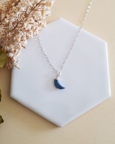 There has always been something magical about the Moon. Add a celestial touch to any outfit with this Blue Moon Pendant Necklace.A dainty natural Blue Opal Crescent Moon is displayed from your choice of Sterling Silver or 14k Gold Filled chain. Both finishes are not plated, lead and nickel free and safe for everyday wear.Blue Opal is associated with the throat chakra, it is believed to be the stone of courage and ingenuity. Soothing light blue gemstone, it is regarded as a strong healing stone t Spiritual Blue Moon Necklaces, Blue Moon Charm Necklace For Jewelry Making, Handmade Blue Moon-shaped Necklaces, Blue Moon Charm Necklaces For Gifts, Handmade Blue Moon Necklaces, Blue Moon Charm Necklace Gift, Blue Moon Charm Necklace For Gift, Dainty Blue Moon Charm Jewelry, Handmade Blue Moon Shaped Necklace