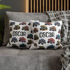 two pillows with cars on them sitting on a couch