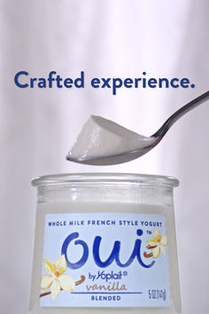 a jar of yogurt with a spoon sticking out of it that says crafted experience