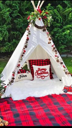 a teepee tent with pillows and christmas decorations