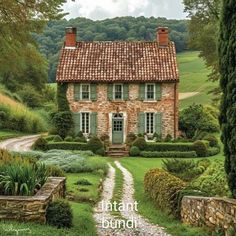 an old brick house surrounded by greenery and stone steps leading to the front door