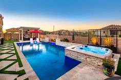 a backyard with a pool and hot tub