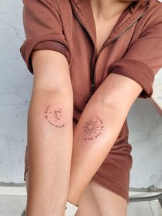 two women with sun and moon tattoos on their arms