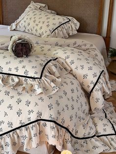 a bed with ruffled bedspread and pillows