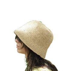 This hat is handmade and crafted from raffia yarn. Raffia yarn is a natural and durable material, ensuring the hat's longevity. The beige color and simple design make it an ideal accessory for both everyday use and outdoor activities like the beach. The wide-brim bucket shape provides sun protection and offers a stylish look. Its comfortable and lightweight structure ensures easy and prolonged wear. Raffia. You can store this hat, knitted from raffia rope, in a breathable cloth bag, protect it from fire and heat, and wipe the stains with a clean damp cloth. Eco-friendly Toquilla Straw Hat, Handwoven Brimmed Toquilla Straw Hat, Handwoven Toquilla Straw Brimmed Hat, Spring Beach Cloche Hat One Size, Natural Woven Wide Brim Bucket Hat, Natural Straw Bucket Hat With Flat Brim, Wide Brim Natural Woven Bucket Hat, Wide Brim Woven Bucket Hat In Natural, Woven Straw Bucket Hat With Flat Brim