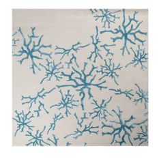 an area rug with blue and white corals on the side, in front of a white background