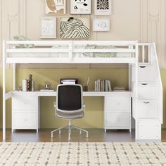 a white loft bed sitting under a desk next to a wall mounted art work space