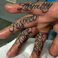 two hands with tattoos on them that say family and someone else is in the middle