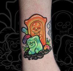 a tattoo on the leg of a person with a bear and skull in front of it