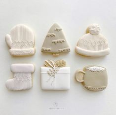 christmas cookies are arranged in the shape of hats, mittens, and snowflakes