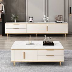 a living room filled with furniture and a white coffee table on top of a rug